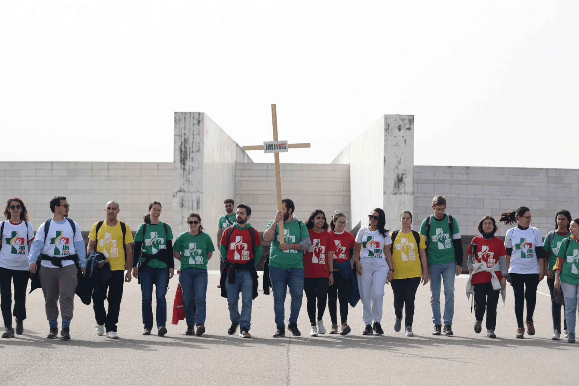 Young team leaders, wearing Journey t-shirts, arrive at the Shrine of Fatima with a wooden Cross